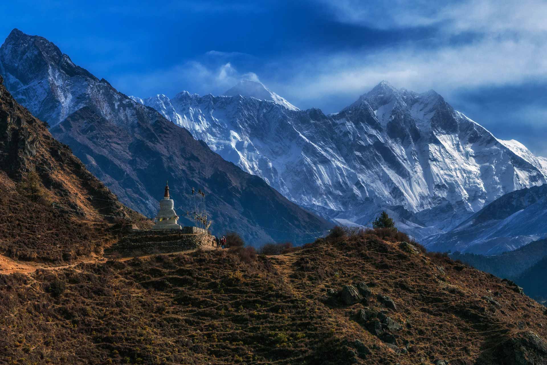 Mount Everest peak towering above clouds and Himalayan landscape