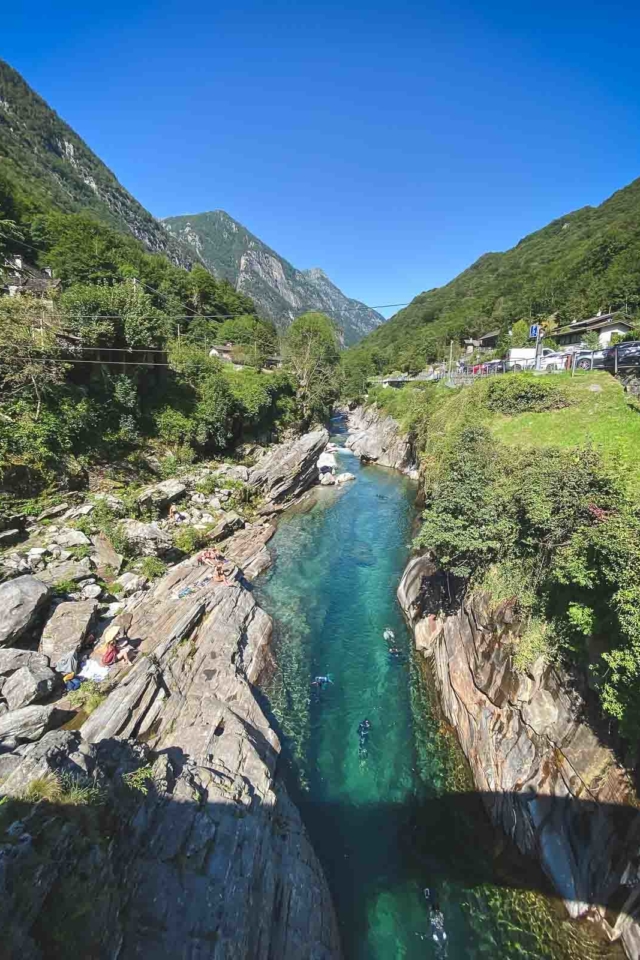 Swimmers in turquoise waters of Verzasca Valley – top day trip in Ticino