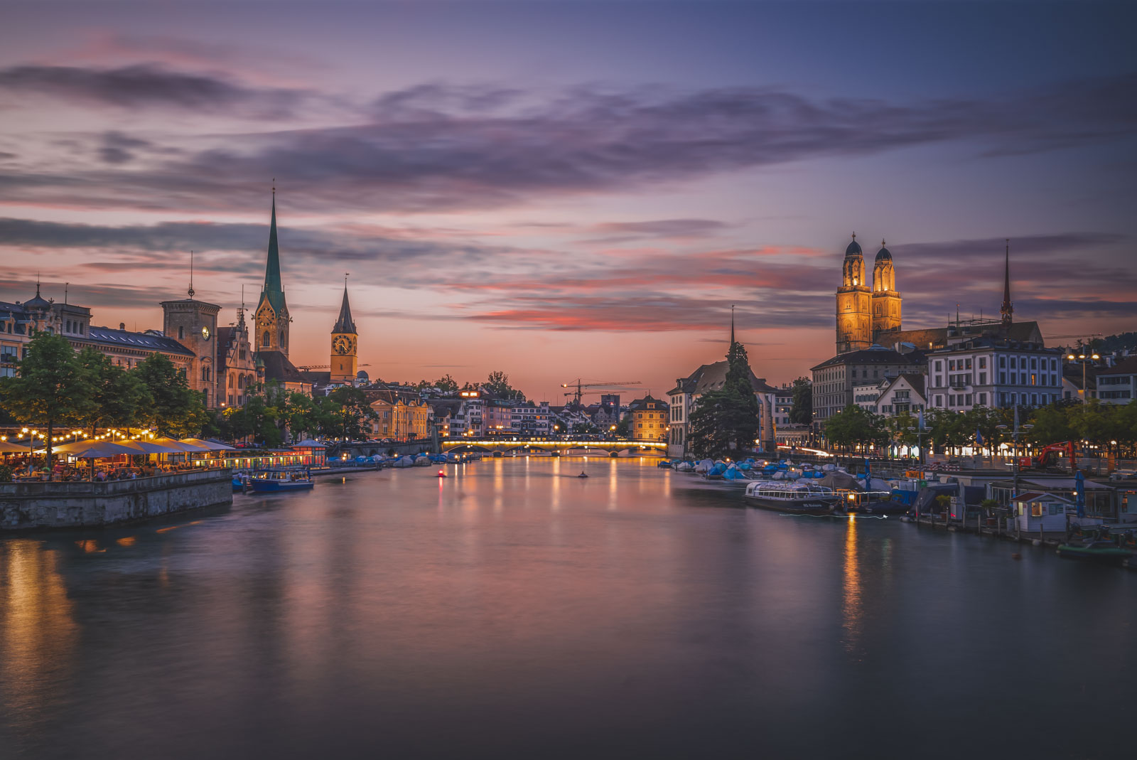 Zurich Old Town at sunset with reflections on the Limmat River and iconic church towers