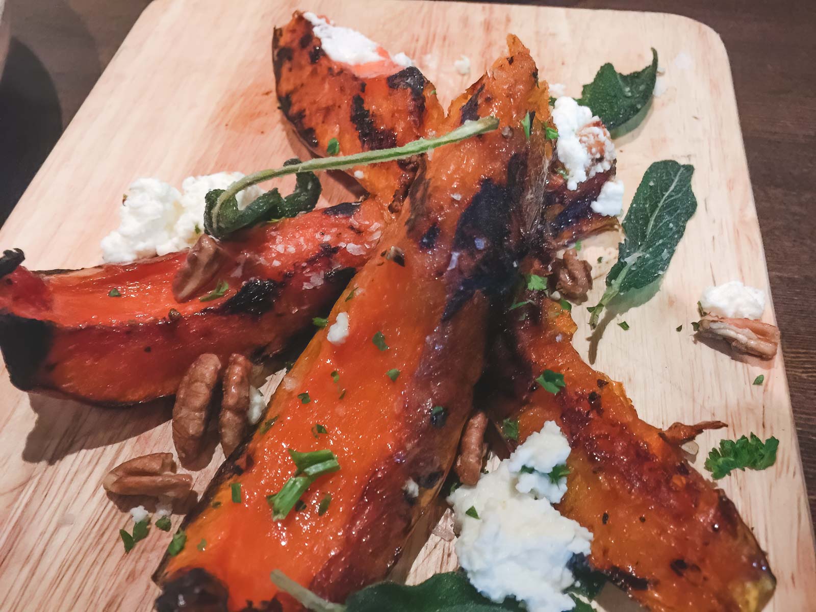 A beautifully plated dish paired with a glass of craft beer from a local restaurant on the Jasper Food Tour.