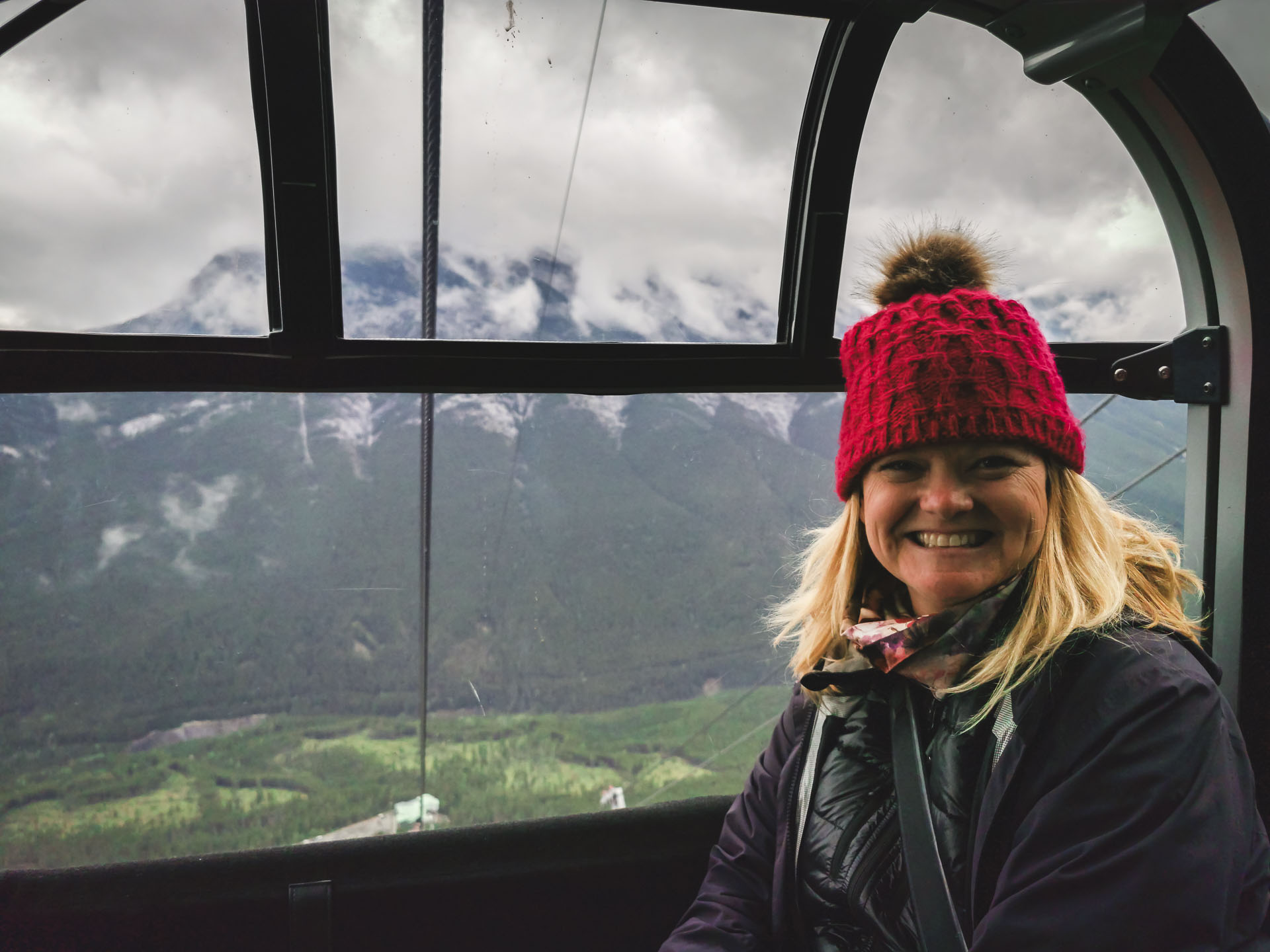 Deb from The Planet D on the Jasper SkyTram on Whistlers Mountain with a  stunning panoramic view of the Rocky Mountains in the background
