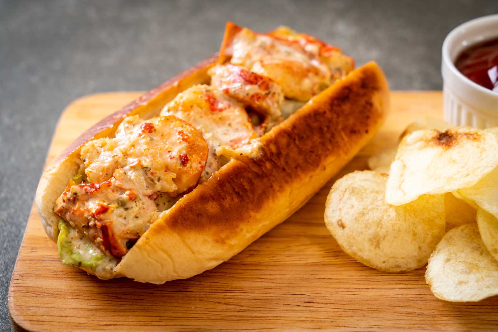  fresh Nova Scotia lobster roll packed with meat, served with a side of chips.