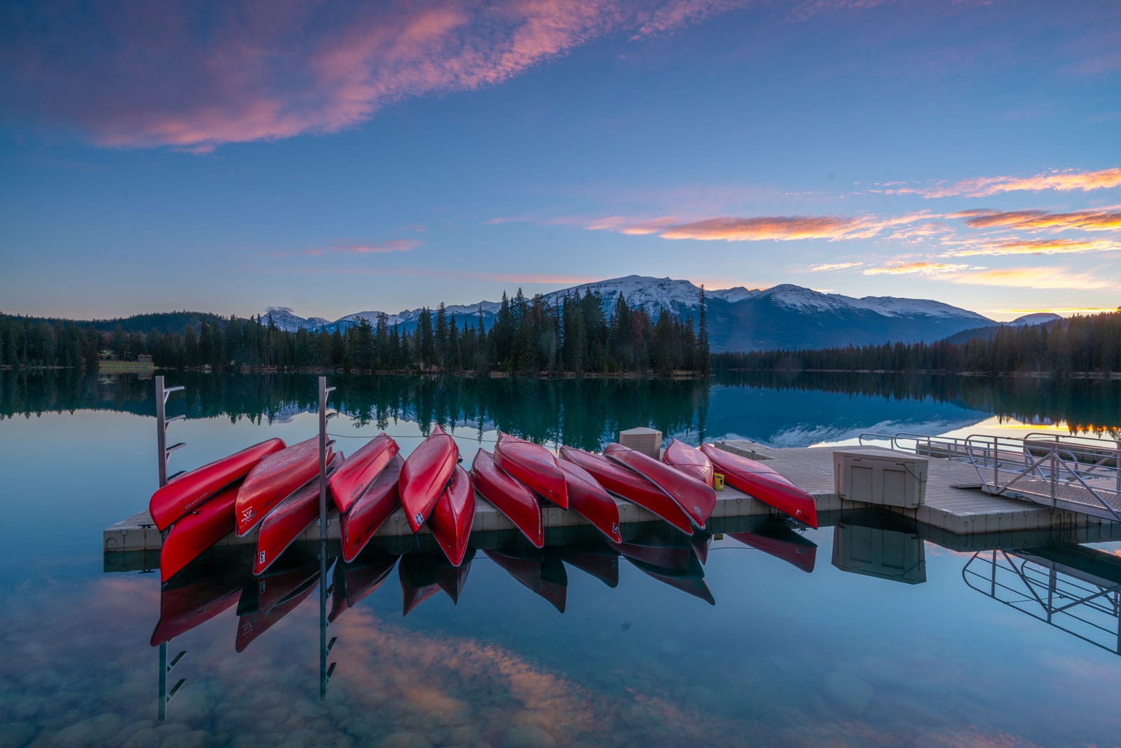 Sunset with Canoes for rent at The historic Fairmont Jasper Park Lodge situated on the shores of the stunning, turquoise Lac Beauvert.