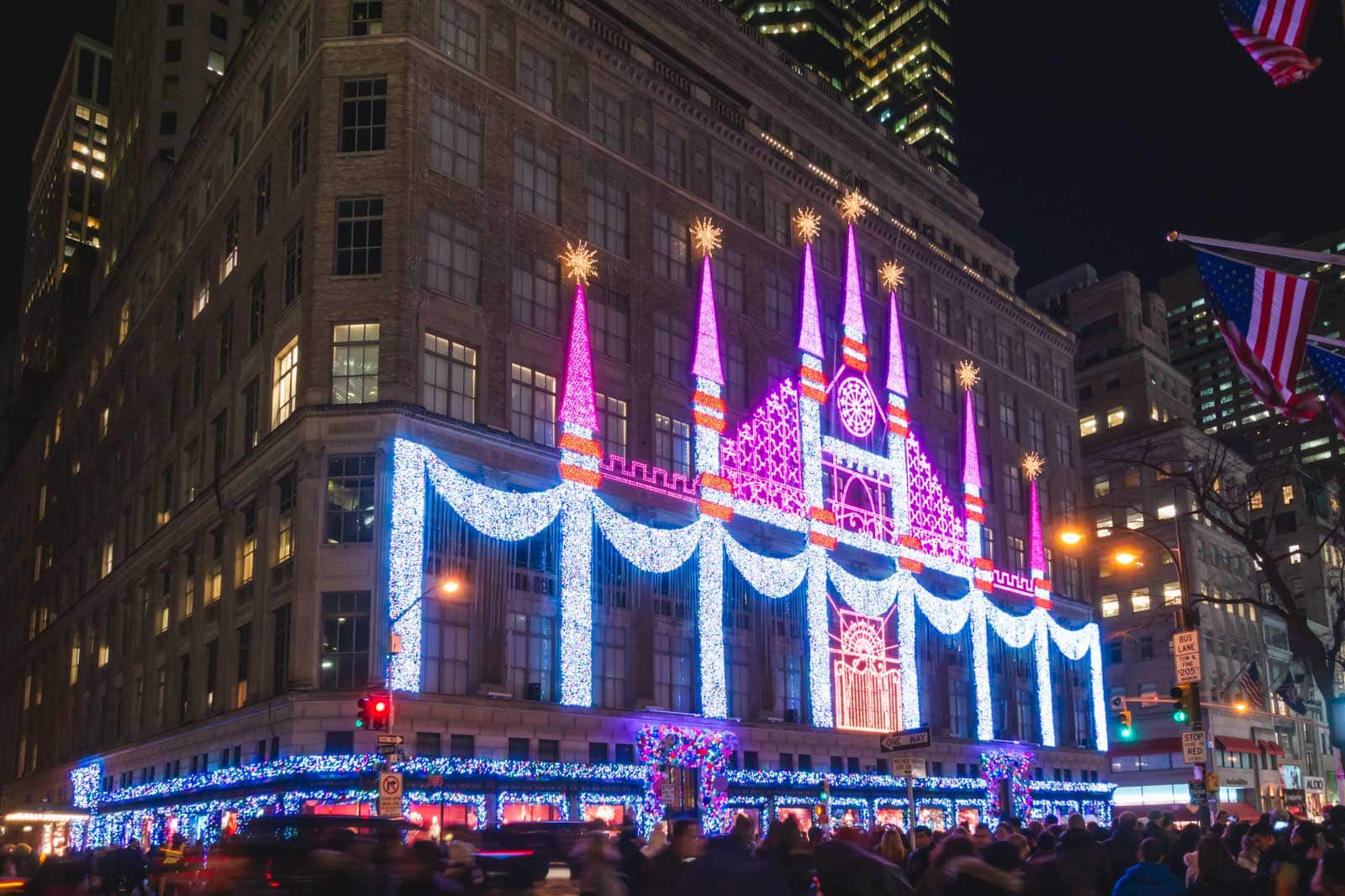 The entire facade of the Saks Fifth Avenue department store illuminated with a spectacular Christmas light show at night.
