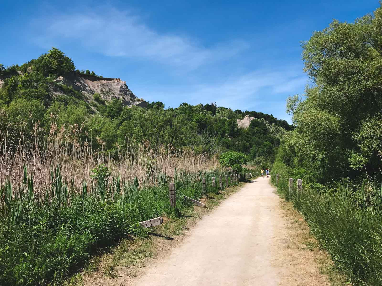 walking path along the massive white cliffs of the Scarborough Bluffs rising above the blue water of Lake Ontario.