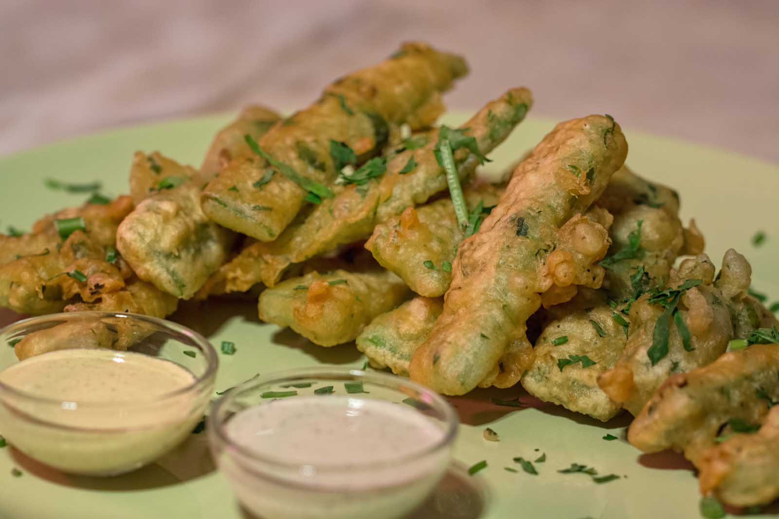 A plate of crispy, tempura-style fried green beans, known as Peixinhos da Horta in Portuguese cuisine.