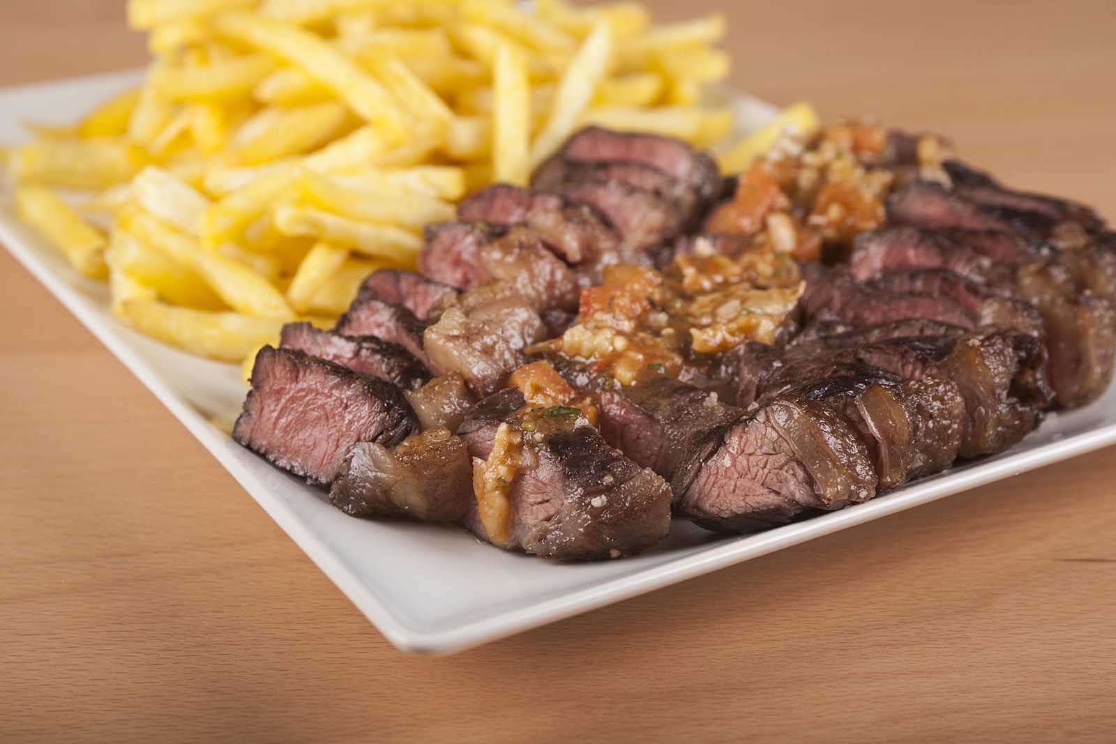 Slices of juicy, grilled Picanha steak, served with french fries. a popular Brazilian-style barbecue dish in Portugal.