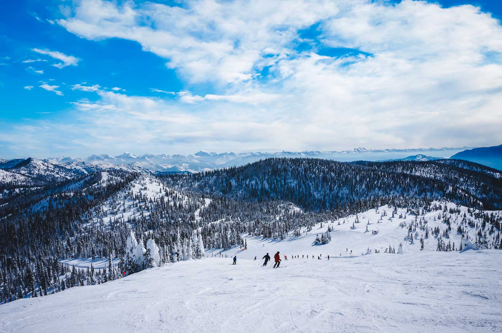 A person snowshoeing on a trail in Glacier National Park near Whitefish, Montana, a great December adventure.